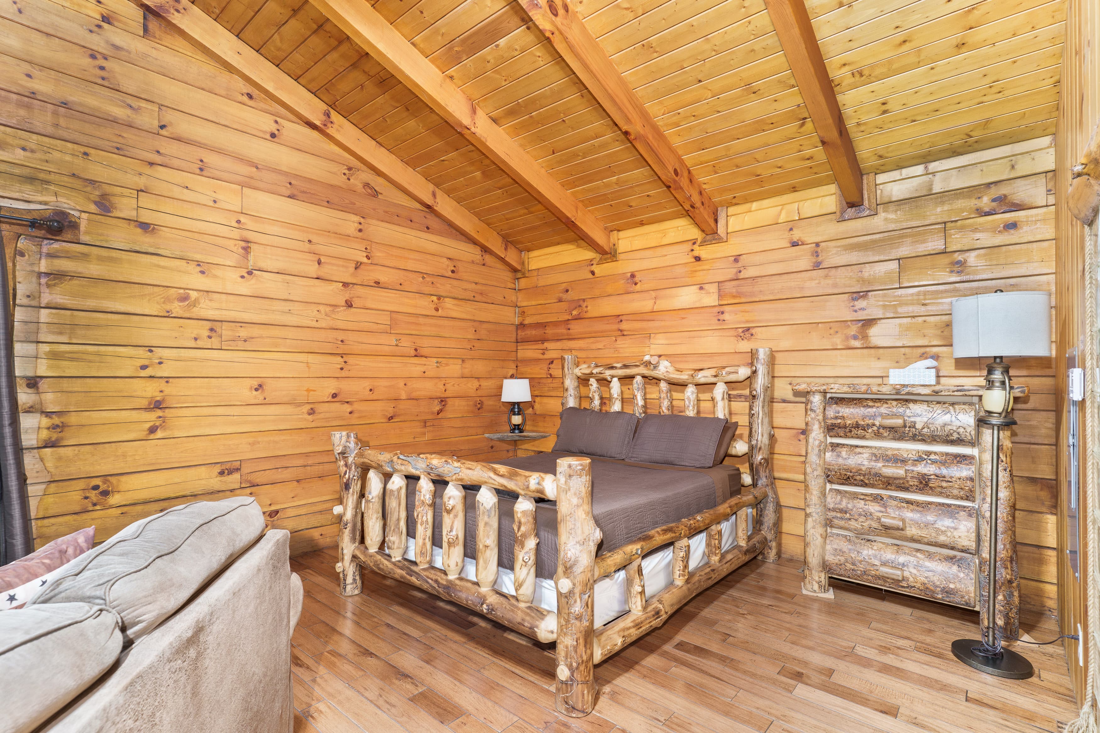 Cozy lodge-style bedroom featuring a wooden bed and rustic decor.
